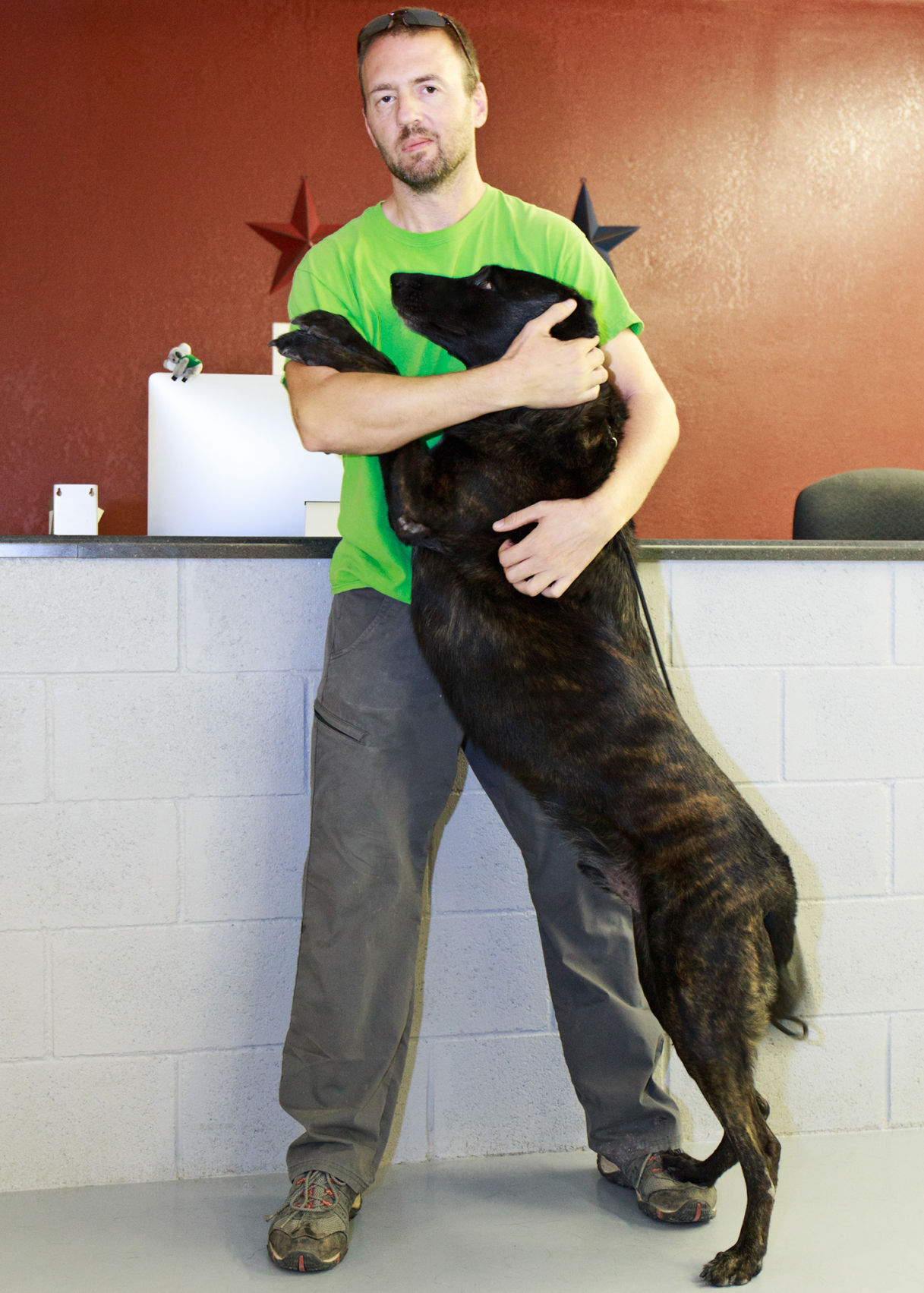 Nathan Braaten get a hug from Czar, a retired police dog